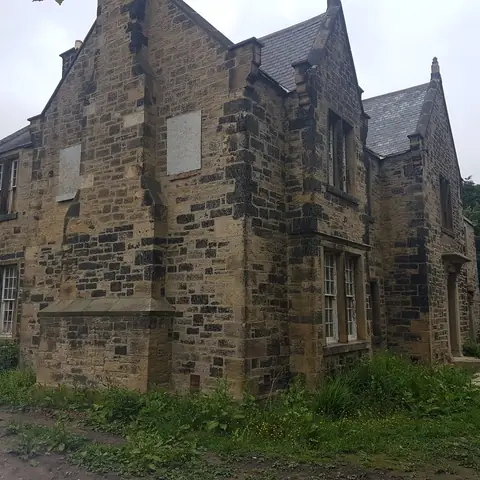 Stone house side elevation before cleaning