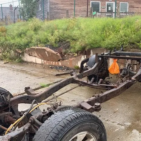 Rusted classic vehicle chassis before restoration