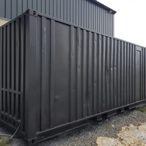 Shipping container painted black after blasting
