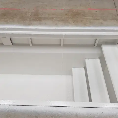 Steel tank interior coated white