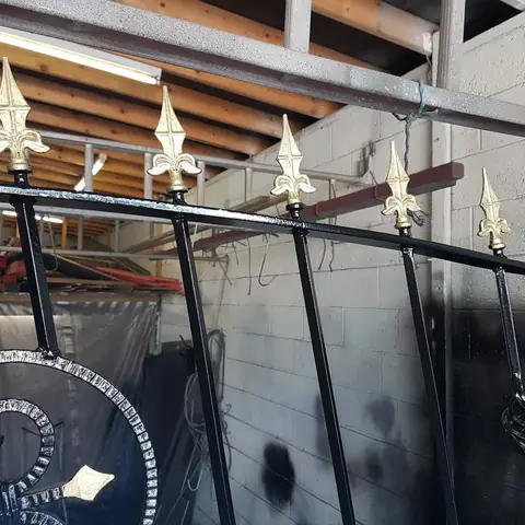 Black iron gates with gold spear tops