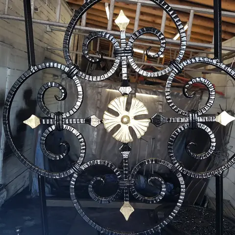 Ornate scrollwork on restored gates