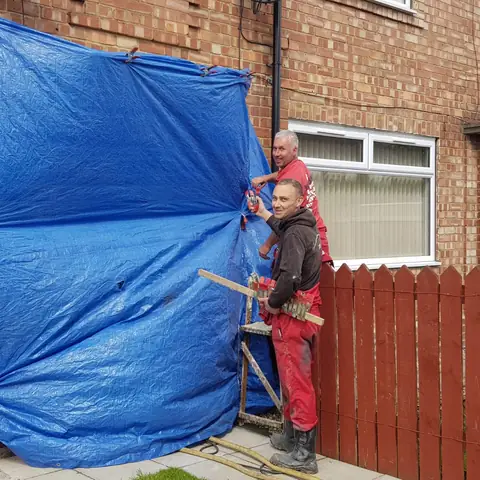 Sheeting up house before brick cleaning