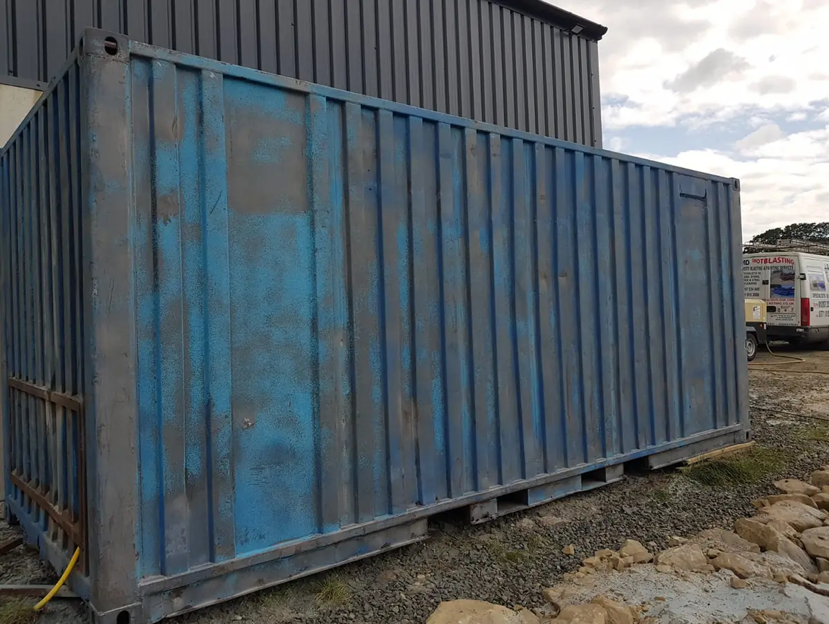 Rusted shipping container before blasting